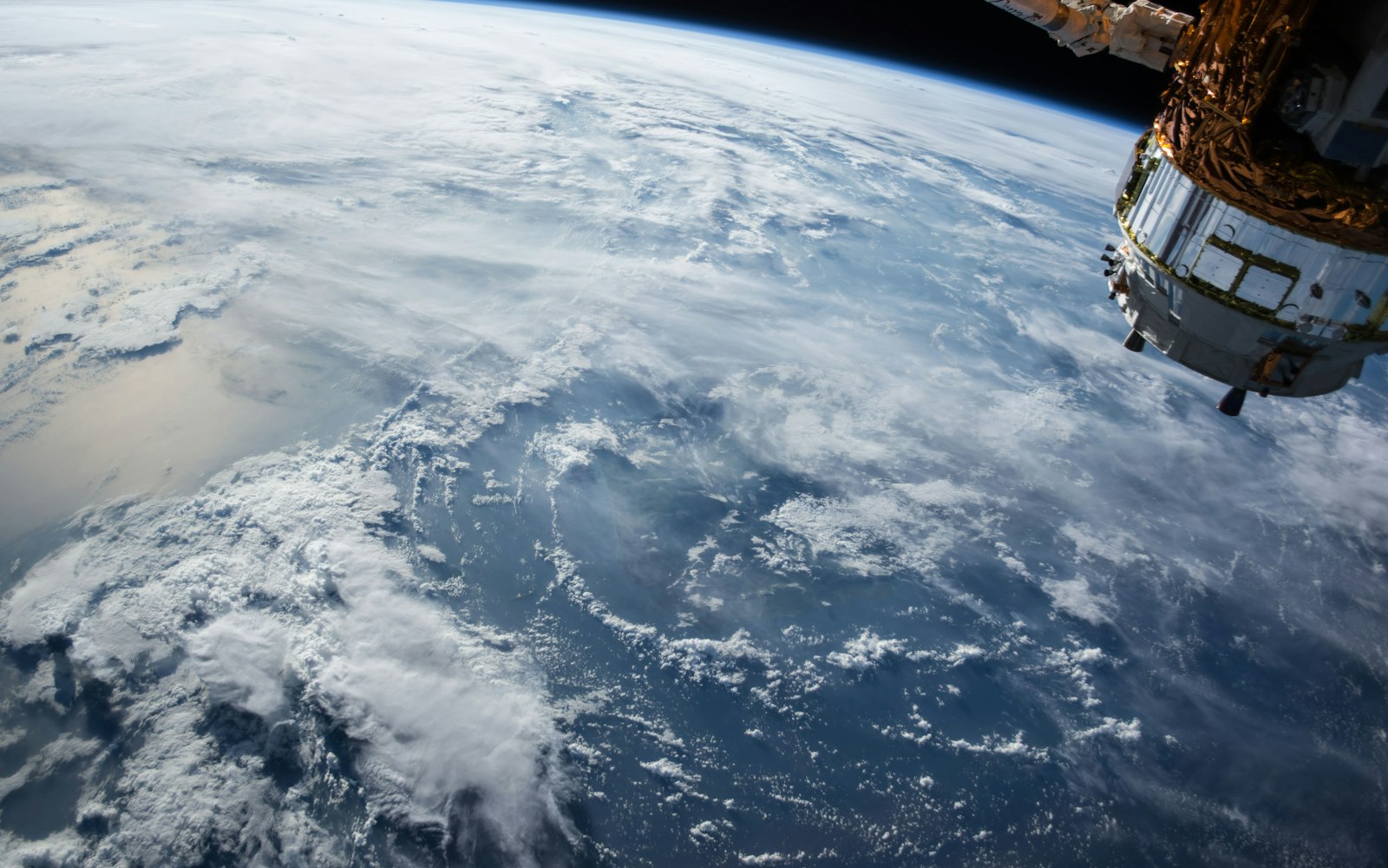 Earth seen from orbit with a spacecraft in the frame