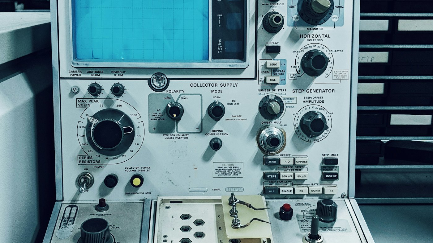Electronic test instrument with dials and a display