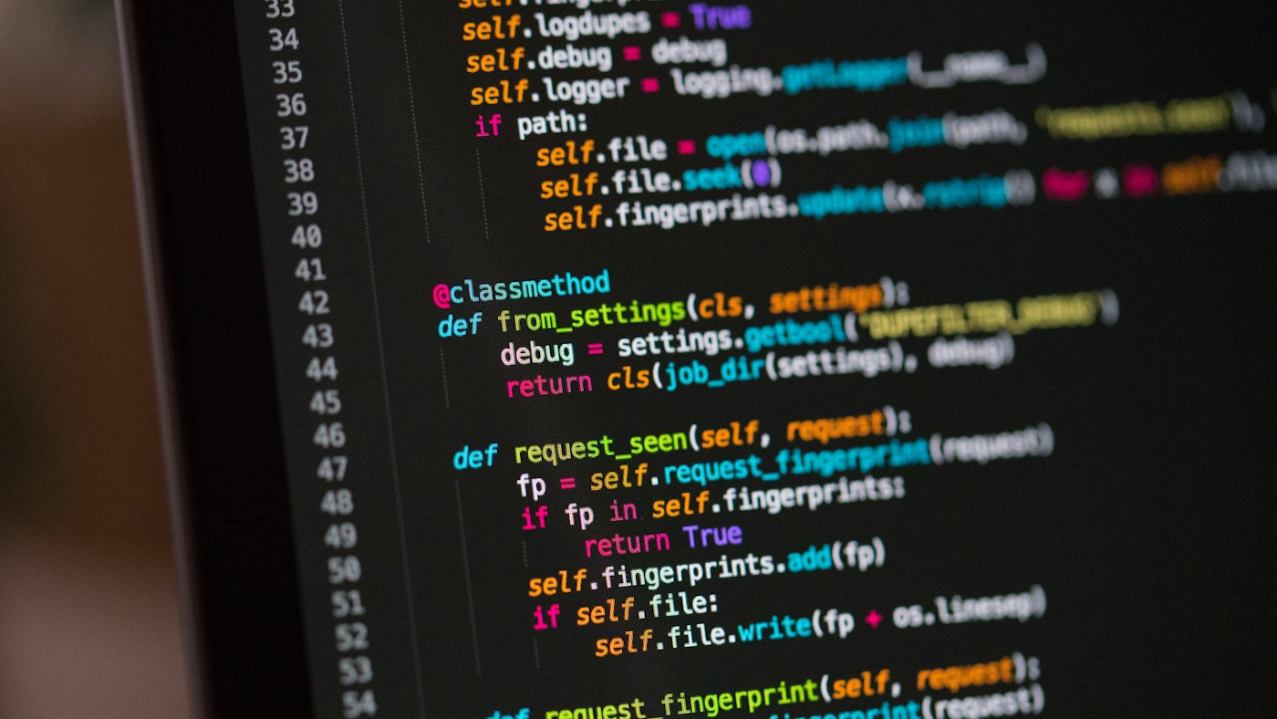Source code in a dark editor on a laptop screen